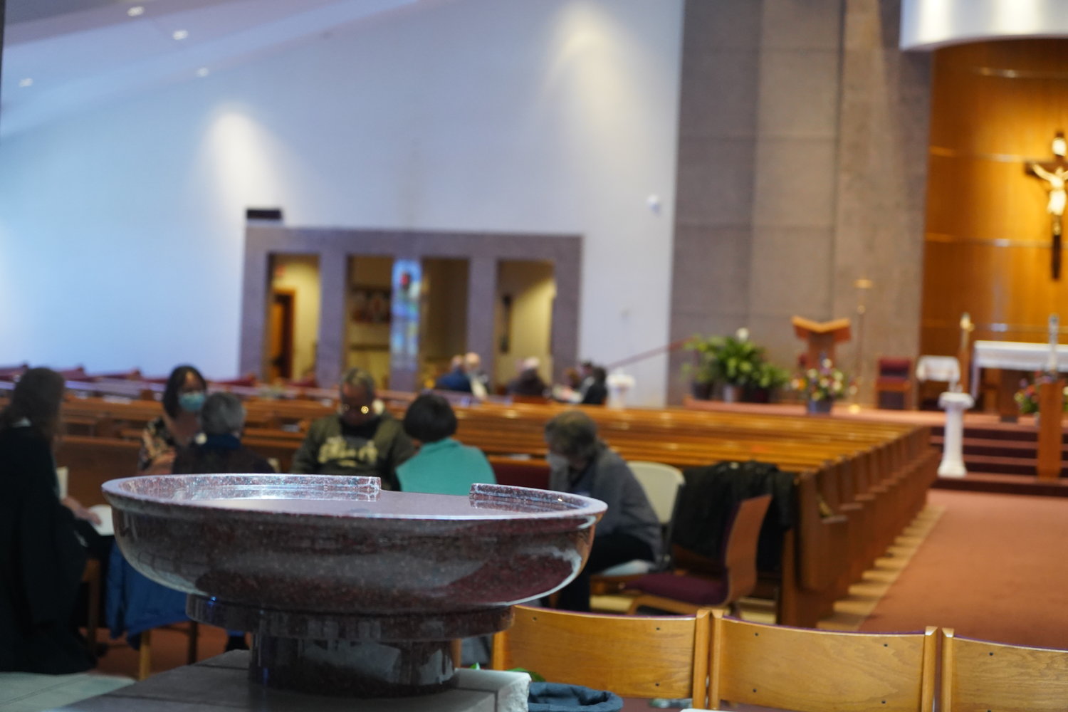 Two of the discussion groups participating in the Columbia listening session for the Synod of Bishops are seen from behind the holy water font in Our Lady of Lourdes Church.